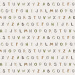 Eigenproduktion 0,5 m Super Soft Bio Jersey "Speckles Buchstaben" hellbeige bunt Meterware